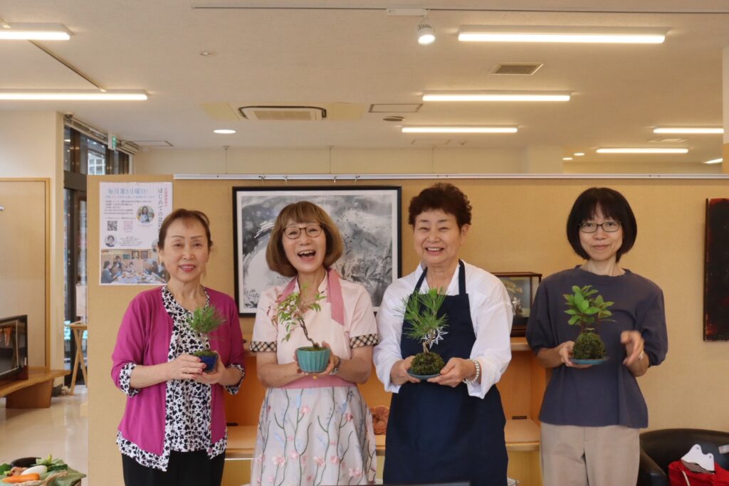 完成した作品を手にした4人の記念写真